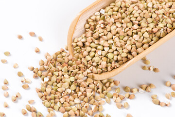 Pile of raw buckwheat isolated on white background.
