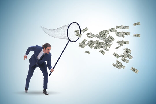 Young businessman catching dollars with landing net