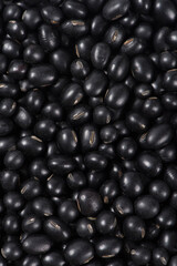 Close-up raw black soya bean textured background.