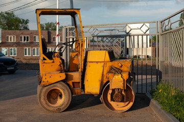 Bulldozer for paving yellow asphalt. Heavy machinery for road repair.