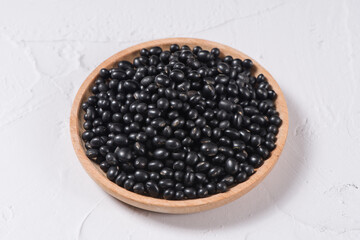 Fototapeta na wymiar raw black soya bean in a wooden bowl