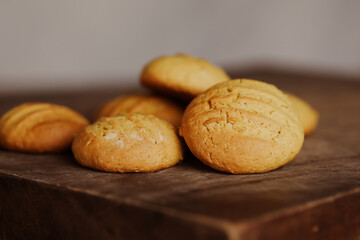 Fototapeta premium Stack of homemade cookies on wooden board. Baking in country kitchen.
