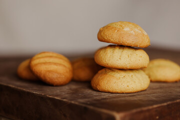 Stack of homemade cookies on wooden board. Baking in country kitchen.
