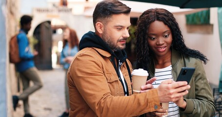 So fun. Waist up portrait view of the curly ginger woman drinking coffee and discussing something at the tablet with her best friend at the city street. Stock video