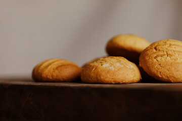 Stack of homemade cookies on wooden board. Baking in country kitchen.