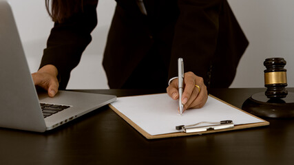 Lawyers work with contract documents and hammer with scales and laptops on the courtroom table. justice and law court judge concept