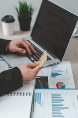Close up of businessman hand using credit card and laptop computer for buying online shopping