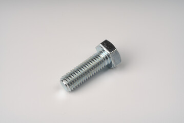 Metal large bolt with thread on white background.