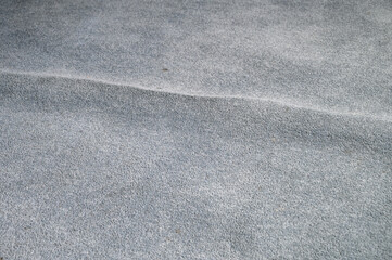 Old, stained, and wrinkled blue carpet poses a tripping hazard, home interior
