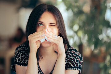 Allergic Woman Blowing her Nose with a Tissue Felling Sick