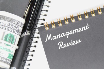 banknotes, pens, notebooks and word management review
