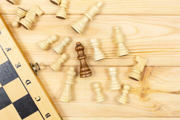 Fototapeta na wymiar Chess board and chess figures on wooden background. Popular logic game for logical thinking.