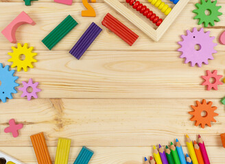 Colorful math fractions, cubes, pencils on wooden table. Interesting mathematics for kids. Education, back to school concept