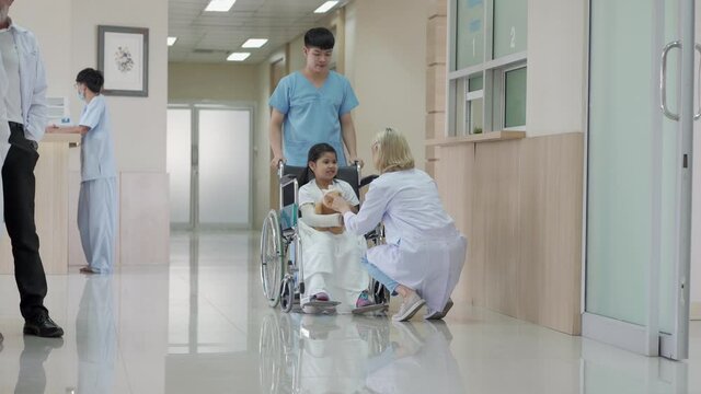 Pediatrician doctor discuss with child patient on wheelchair in the health medical center, Hospital
