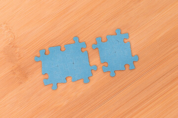 Top View of a Blue Puzzle Peaces Lie on the Wooden Table