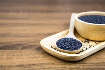 Fototapeta na wymiar Sesame, Close-up black sesame seeds in a wooden spoon for healthy food and diet concepts.