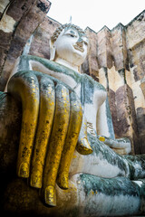 Ancient Buddhas statue Old temple at Sukhothai Historical Park in Thailand.