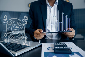 Businessman hands working on tablet computer with network and digital finance marketing chart and future technology innovation and digital transformation concept.