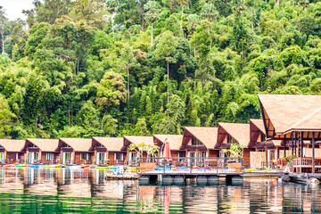 Resort wooden home raft floating and mountain fog on river kwai at Khao Sok National Park, Surat Thani Province, Thailand. Concept image for transportation,boat,nature,scenery,travel,outdoor