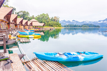 Resort wooden home raft floating and mountain fog on river kwai at Khao Sok National Park, Surat Thani Province, Thailand. Concept image for transportation,boat,nature,scenery,travel,outdoor