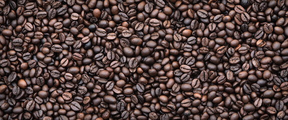Fototapeta premium Coffee beans background.Dark roast coffee beans background, top view