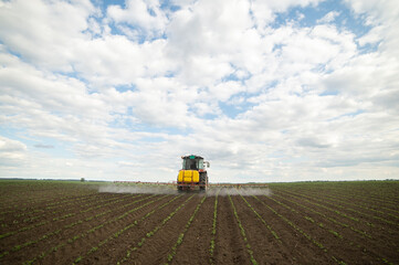 Spraying pesticides at soy bean fields