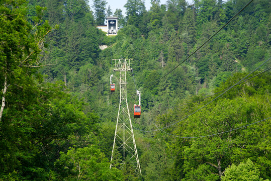 Red cable car at sunny summer day morning arriving at station. Photo taken June 18th, 2021, Zurich, Switzerland.