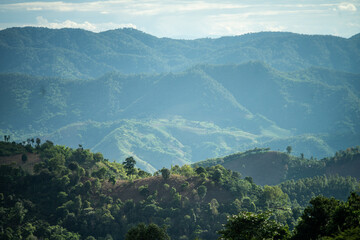 green mountains with thin smoke