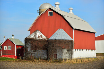 Empty corn silos sit at the end of a red barn on a northeastern Illinois farm.