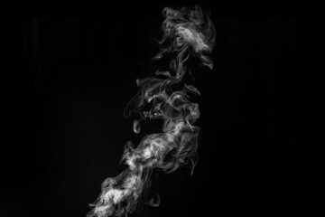 Perfect mystical curly white steam or smoke isolated on black background. Abstract background fog or smog, design element, layout for collages.