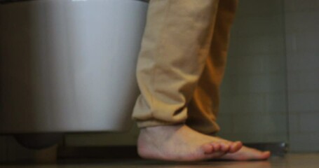 A woman goes to the toilet and sits on the toilet.The process of defecation. Toilet at home. Healthy bowel movements in the morning.