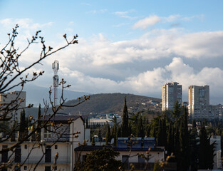 Clouds over buildings hiding mountains in the spring in the city of Alushta in the Crimea.