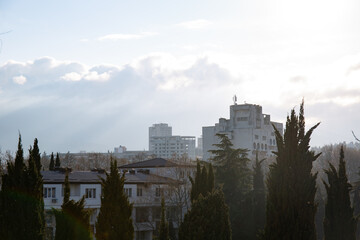 Clouds over buildings hiding mountains in the spring in the city of Alushta in the Crimea.