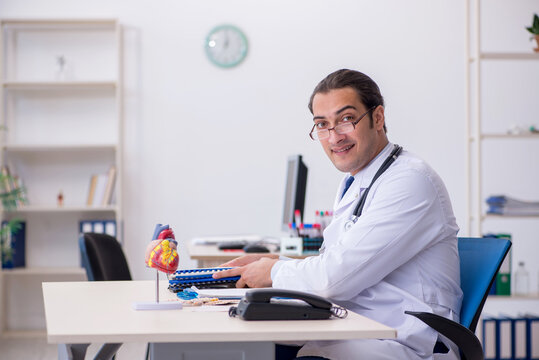 Young male doctor cardiologist working in the clinic