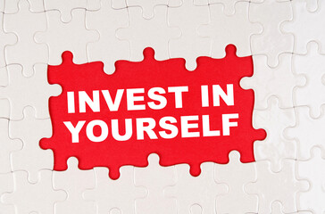 In the middle of the puzzles on a red background it is written - INVEST IN YOURSELF