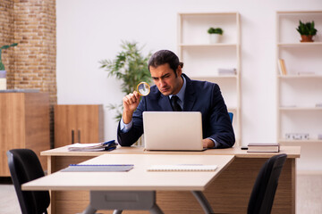 Young male employer sitting in the office