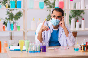 Young male chemist testing soap in the lab