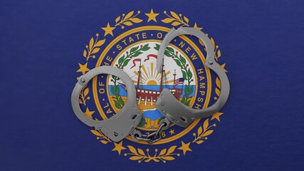 A half opened steel handcuff in center on top of the US state flag of New Hampshire