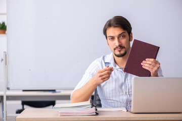 Young male teacher in front of whiteboard