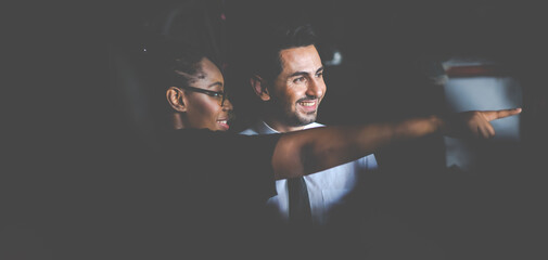 African American female worker and man customer choose and inspecting car part products while working in a old car part warehouse store.