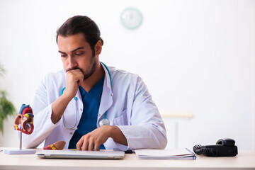 Young male doctor cardiologist working in the clinic
