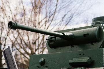 Fragment of a tracked track on green camouflage tank.