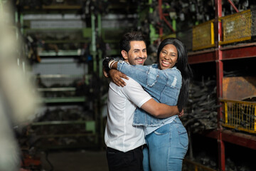 Obraz premium Modeling portrait photo. African American female employee worker and hispanic man manager working together at old auto and car parts warehouse store.