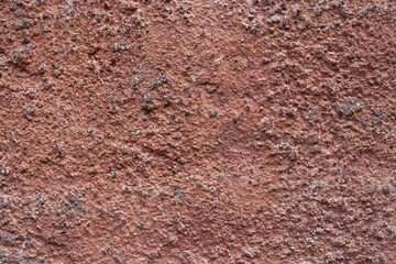 Old red wall surface with scratched paint
