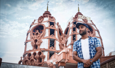 man standing near iskon temple travel image