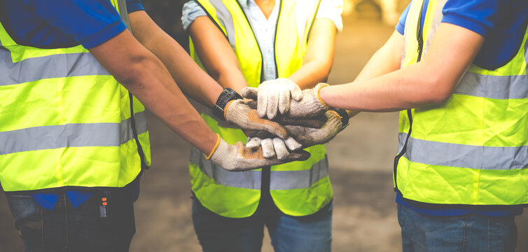 Unity and teamwork concept. team standing hands together. Professional Mechanical Engineer team Working at Second-hand spare parts of old car parts warehouse store.