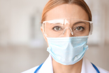 Portrait of female doctor with protective uniform in clinic