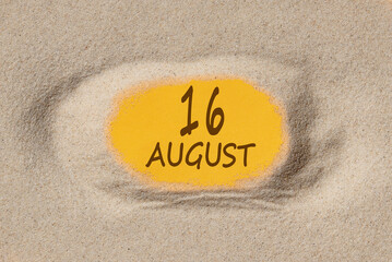 August 16. 16th day of the month, calendar date. Hole in sand. Yellow background is visible through hole. Summer month, day of the year concept