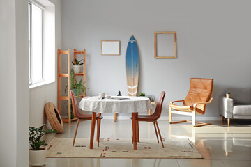 Interior of modern stylish room with surfboard and dining table