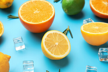 Healthy citrus fruits and ice cubes on color background